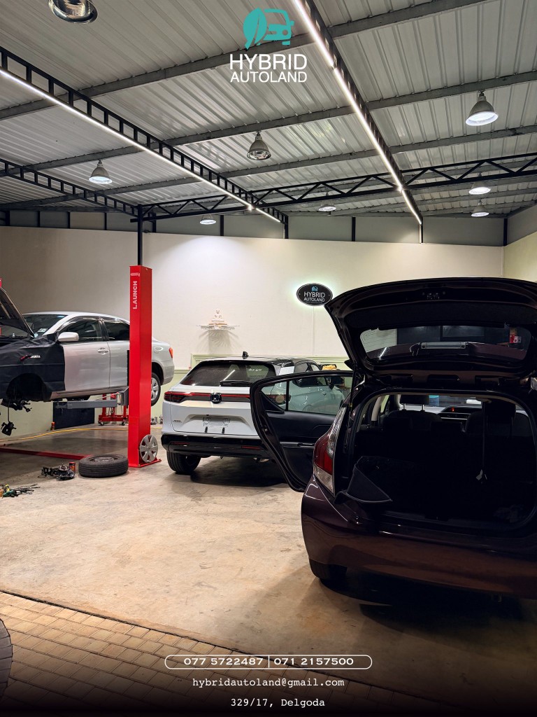 Several vehicles on lifts and in bays at Hybrid Autoland