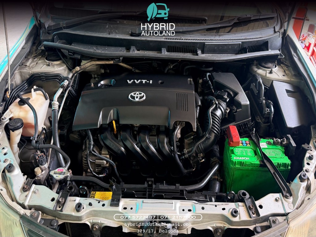 Toyota engine bay with VVT-i cover during inspection at Hybrid Autoland
